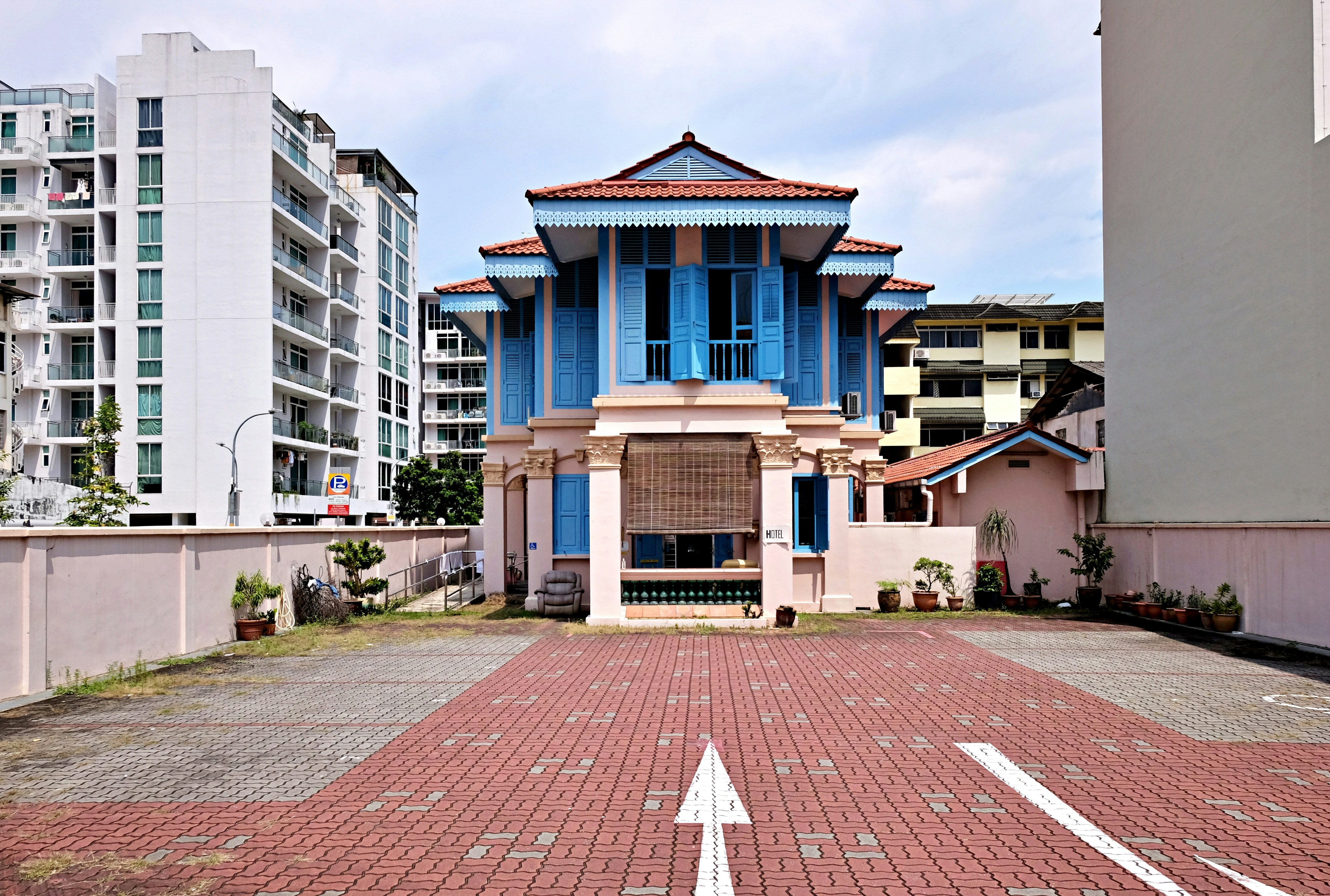 a blue and white building with a white arrow in front of it